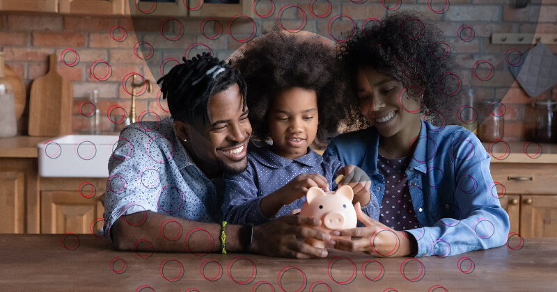 An African-American family gathered around a piggy bank.